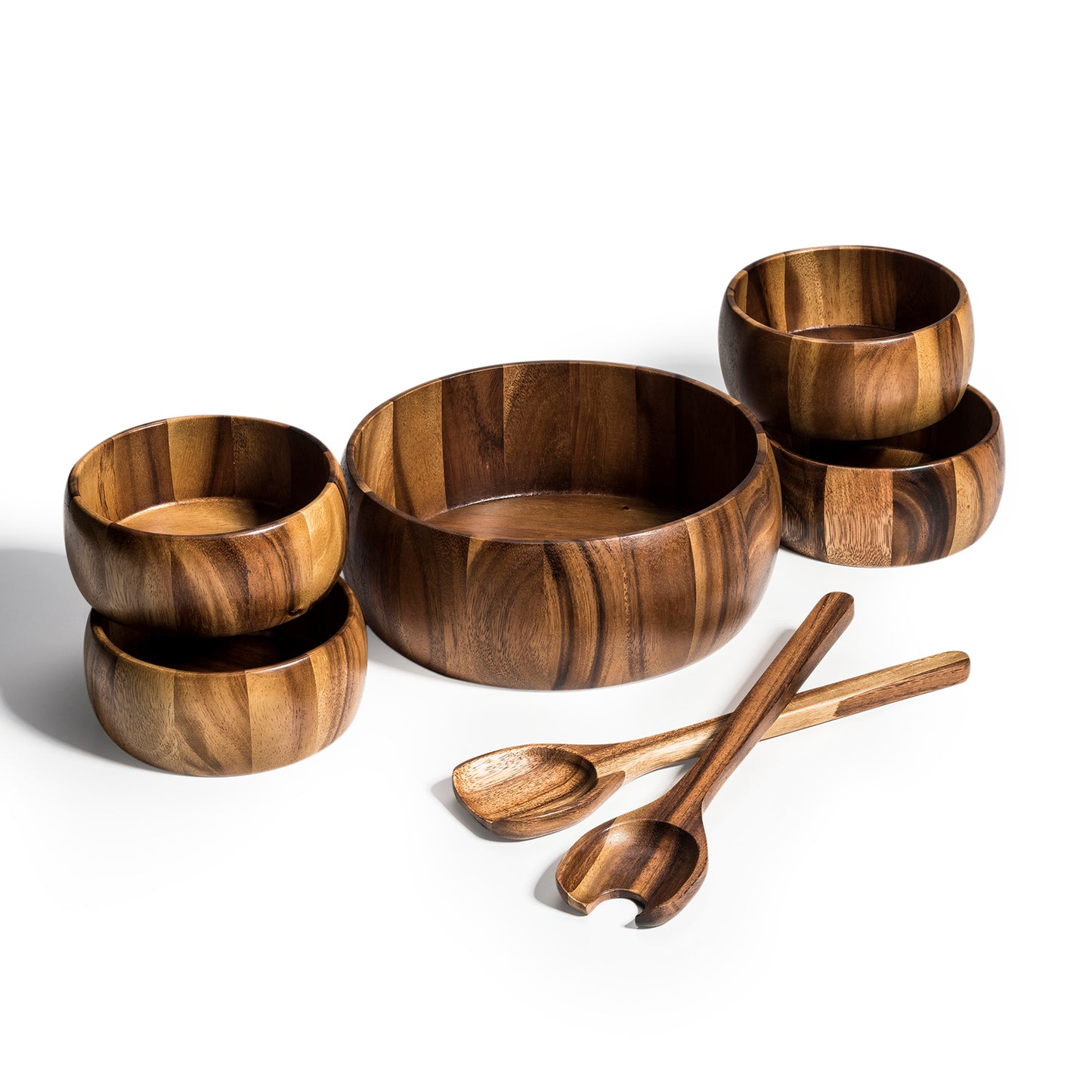 Set of wooden bowls and spoons on a white background