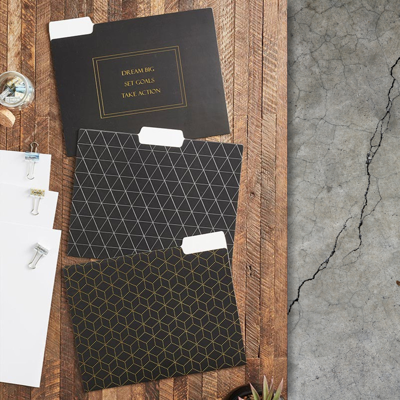 Three black folders with geometric patterns on a wooden surface.