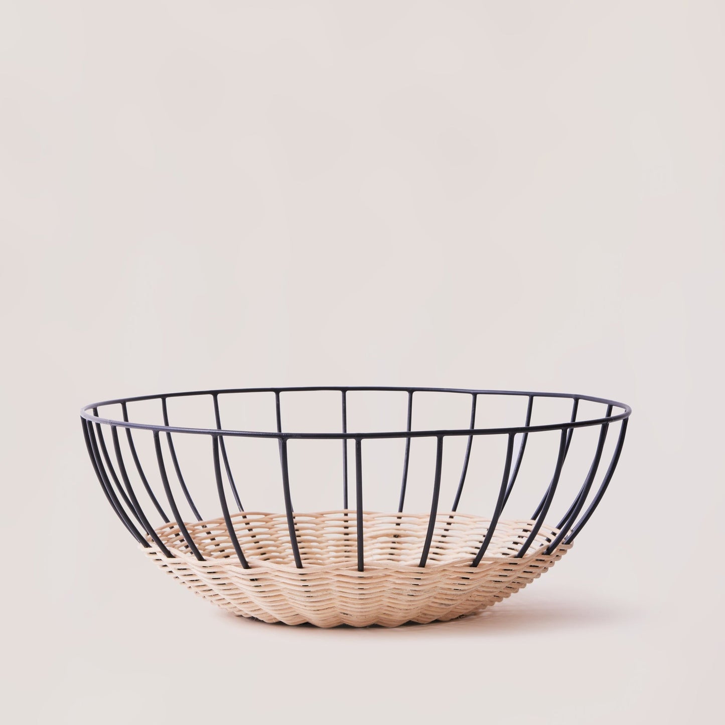 Wire basket with woven base on a light background