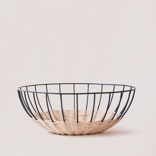 Wire basket with woven base on a light background