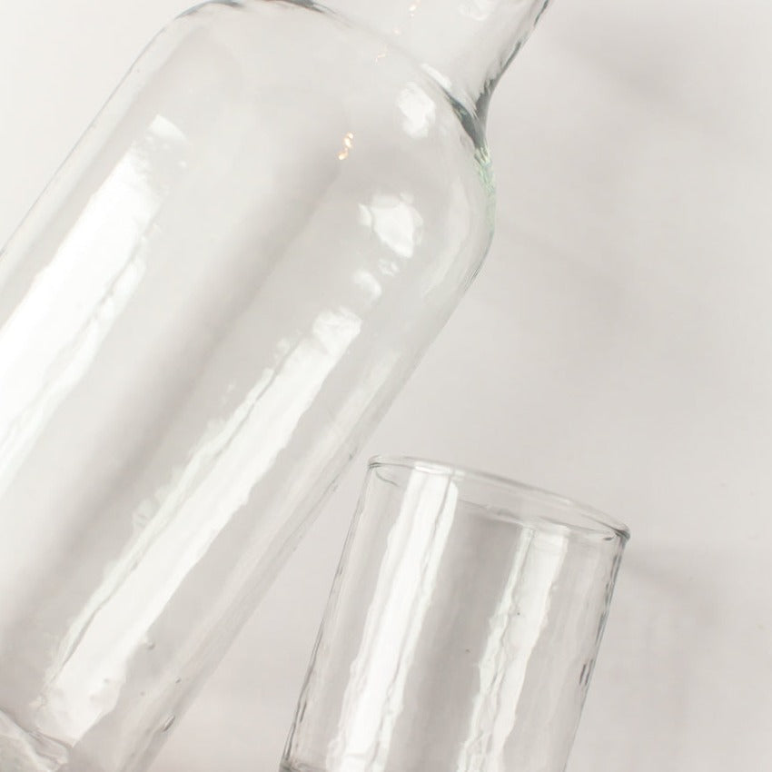 Two clear glass vases on a light gray background
