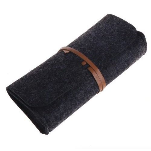 Rolled-up dark gray fabric with a brown leather strap on a white background