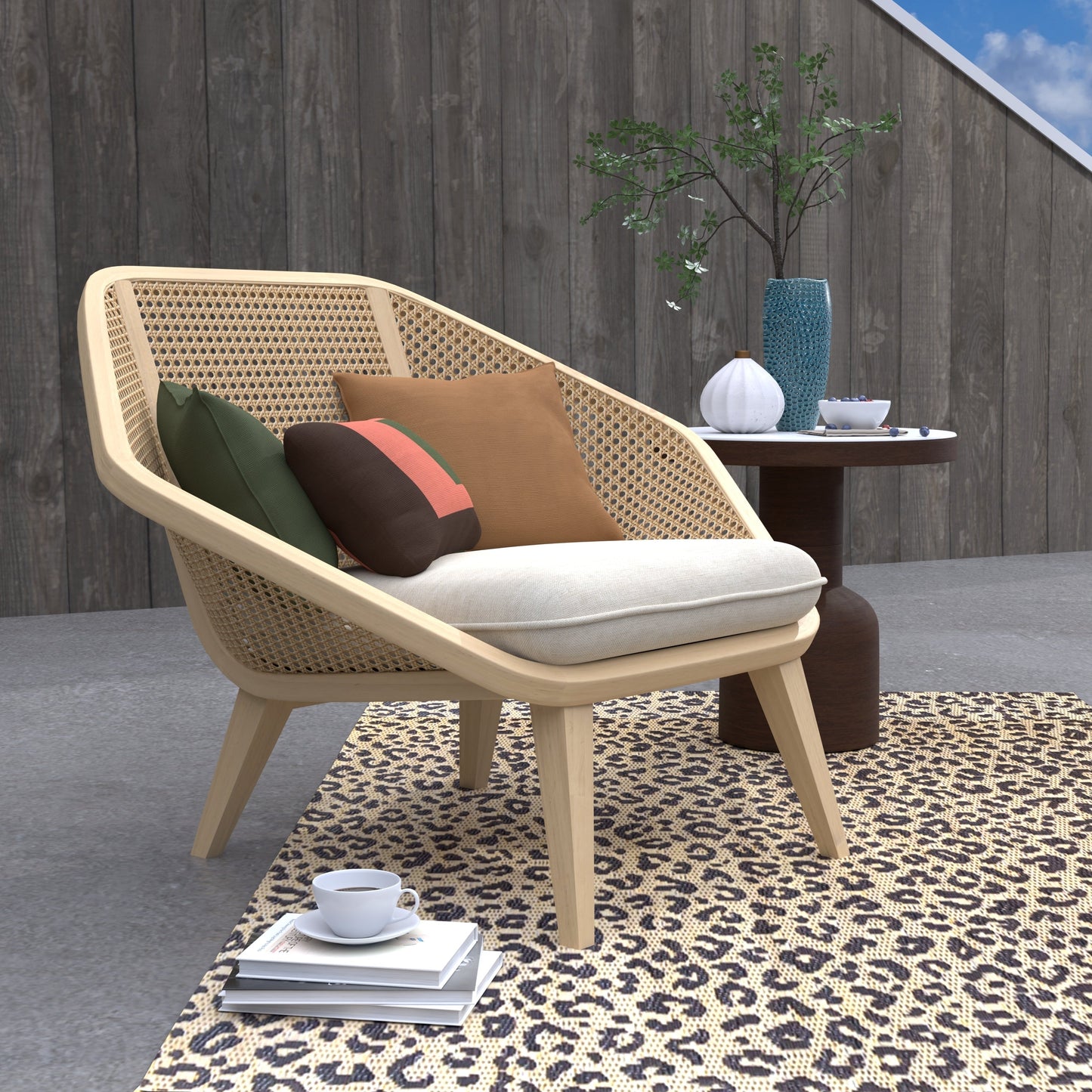 Wicker chair with cushions on a patio area with a wooden wall and plant in the background.