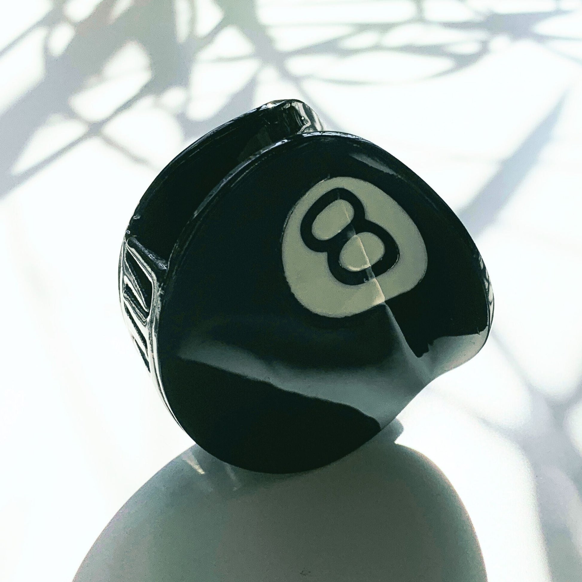 Black billiard ball with number 8 on a white background