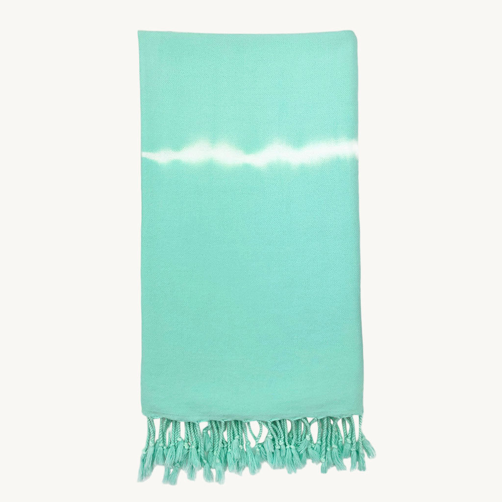 Turquoise towel with white stripe and fringes on a white background