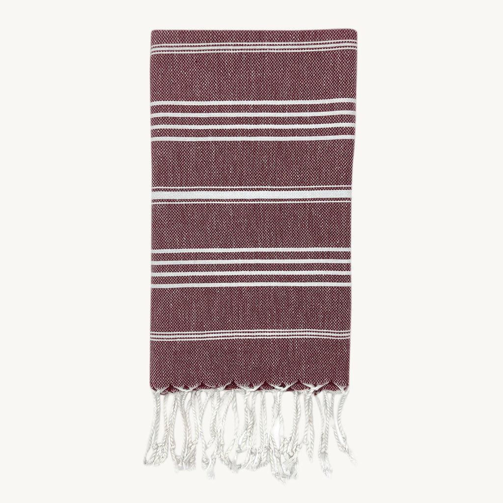 Striped towel with fringes on a white background