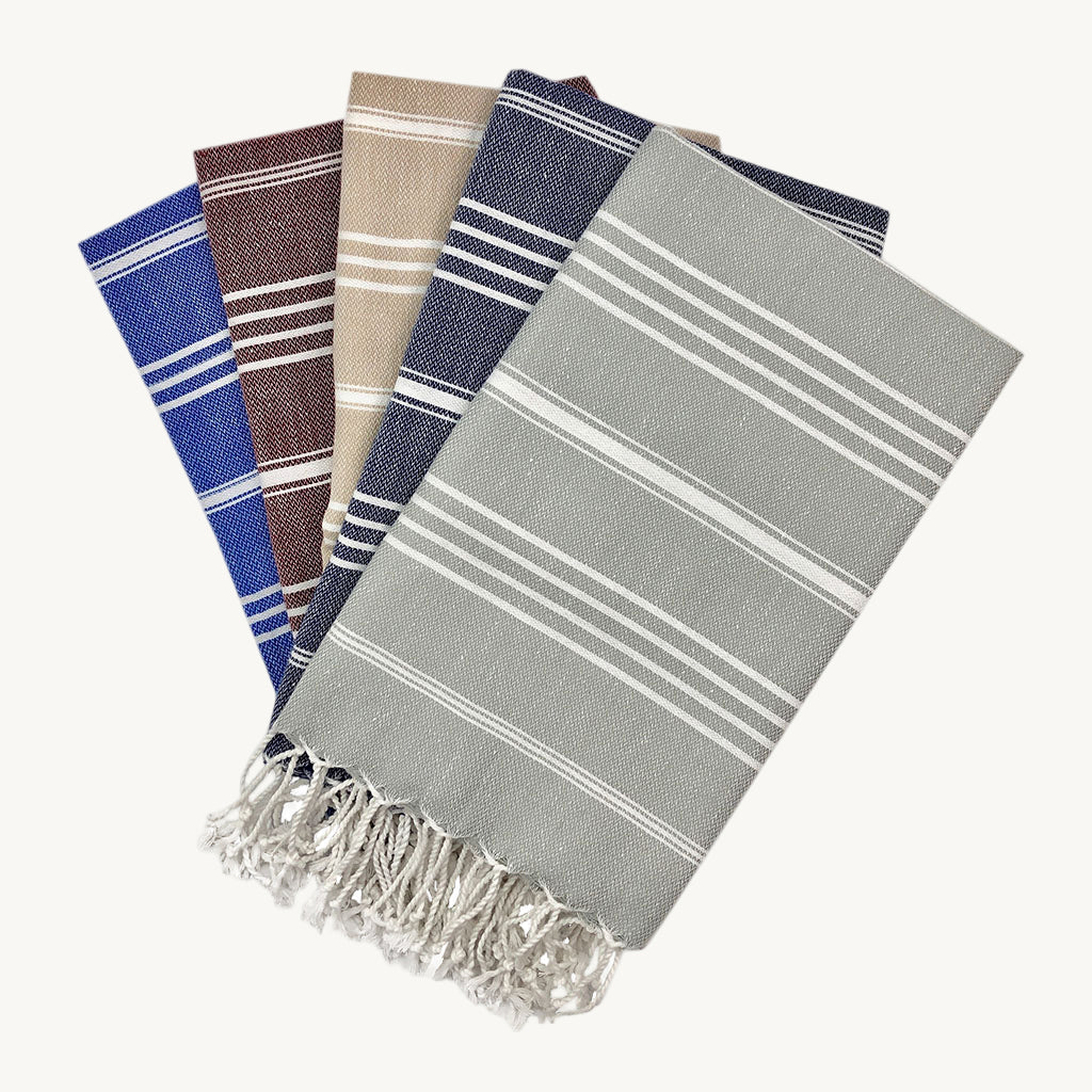 Set of six striped towels in various colors on a white background